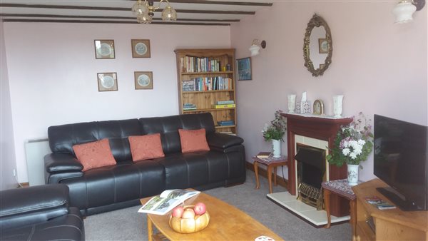 Lounge with patio doors overlooking Wetton Hill